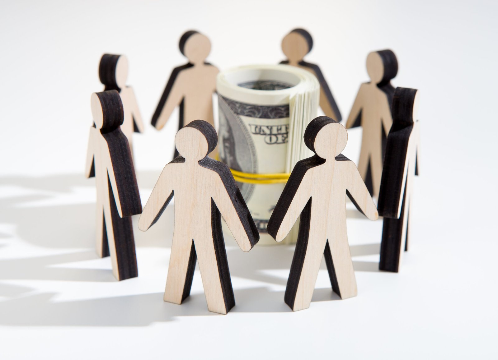 Crowdfunding concept. Close up of investors around savings deciding where to invest