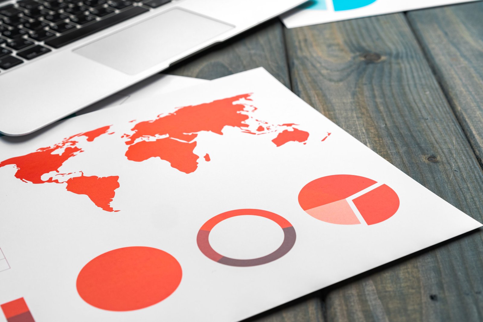 Financial report and laptop on business desk, close up